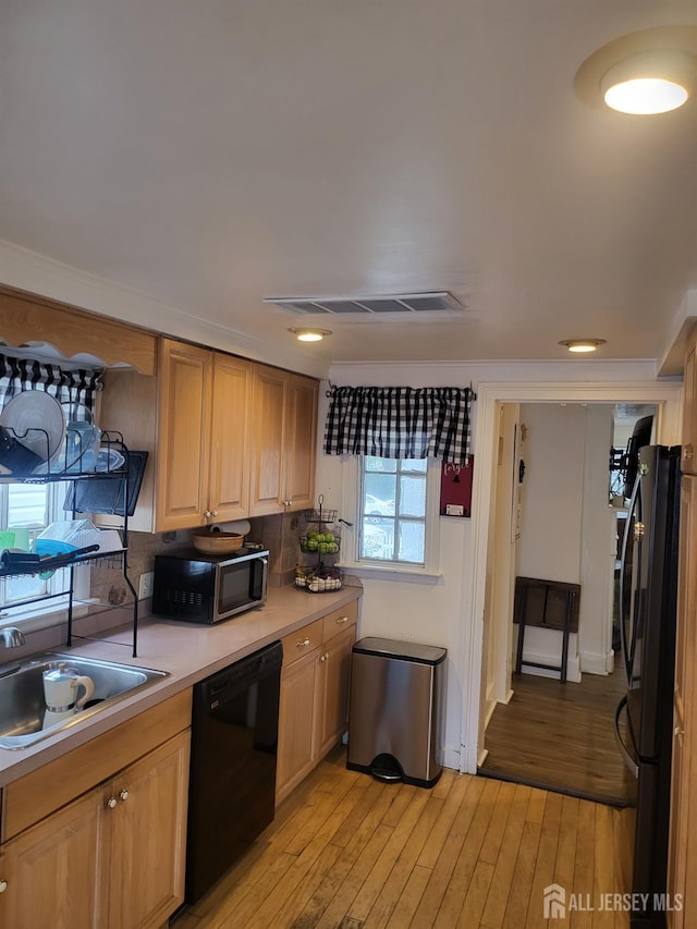72 High St, Perth Amboy, NJ 08861 - kitchen with black appliances, light countertops, light wood-style flooring, and a sink