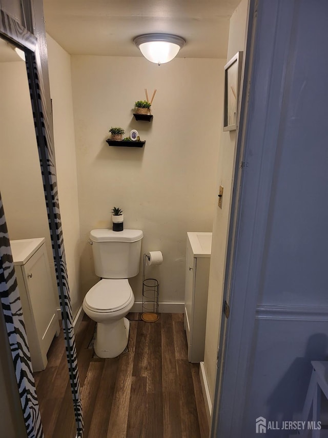 72 High St, Perth Amboy, NJ 08861 - bathroom with vanity, wood finished floors, toilet, and baseboards