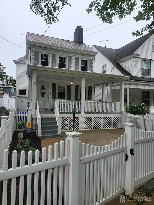 72 High St, Perth Amboy, NJ 08861 - view of front of home with a porch, a gate, a chimney, and a fenced front yard
