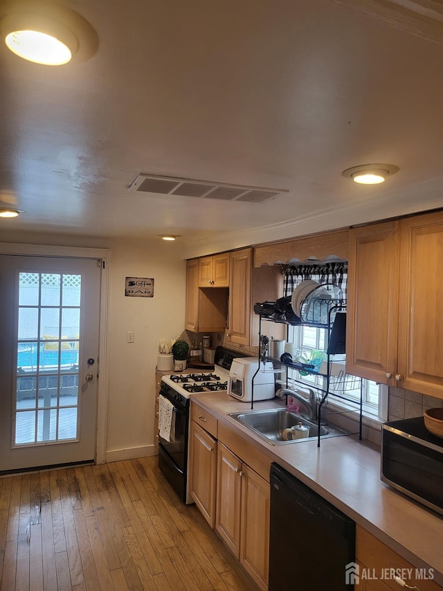 72 High St, Perth Amboy, NJ 08861 - kitchen with dishwasher, range with gas cooktop, stainless steel microwave, a sink, and light countertops
