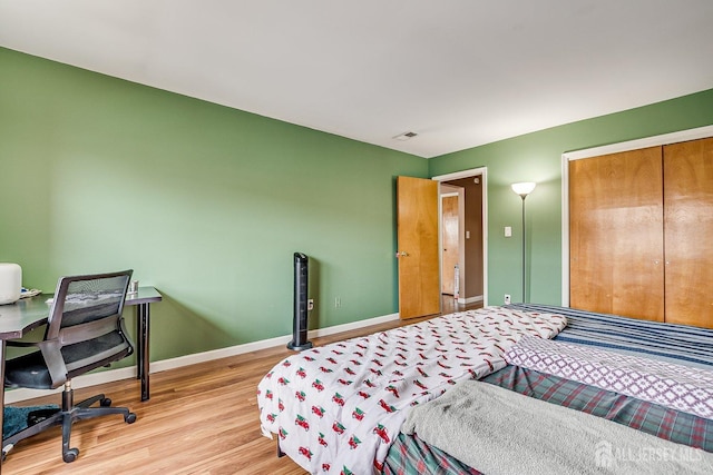 bedroom featuring light hardwood / wood-style floors and a closet