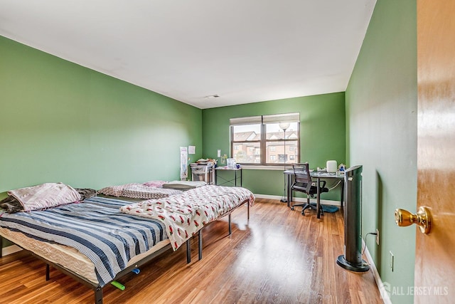 bedroom with light hardwood / wood-style floors