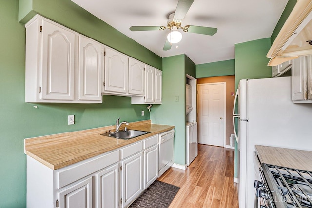 kitchen featuring white appliances, ceiling fan, white cabinets, and sink