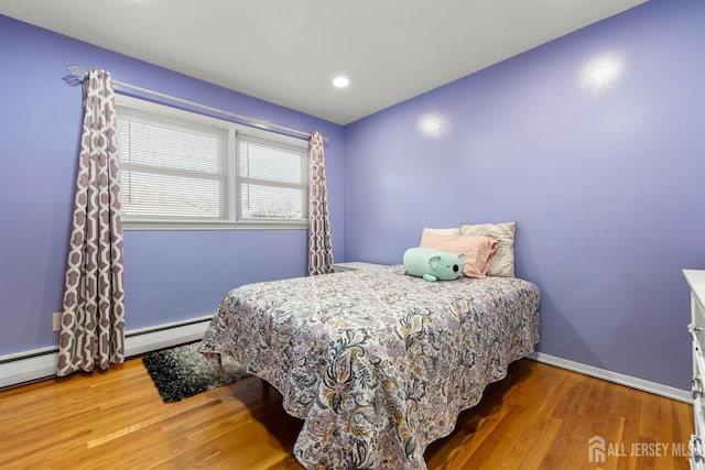 2291 Morrison Ave, Union Twp, NJ 07083 - bedroom with baseboard heating, wood finished floors, baseboards, and a baseboard heating unit