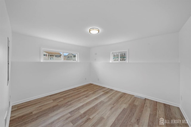 spare room featuring light hardwood / wood-style flooring