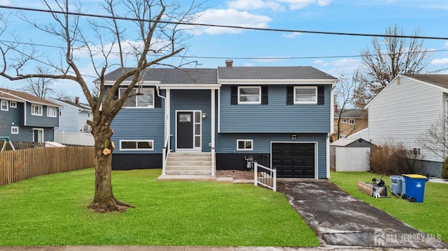 raised ranch with a garage and a front lawn