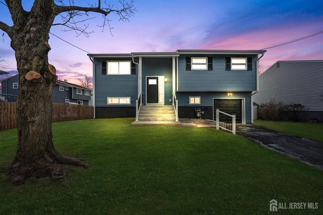 view of front of home featuring a yard and a garage