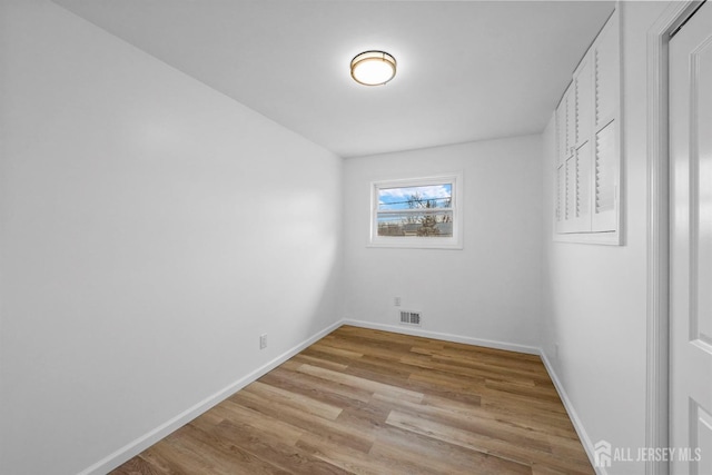 spare room featuring light hardwood / wood-style flooring