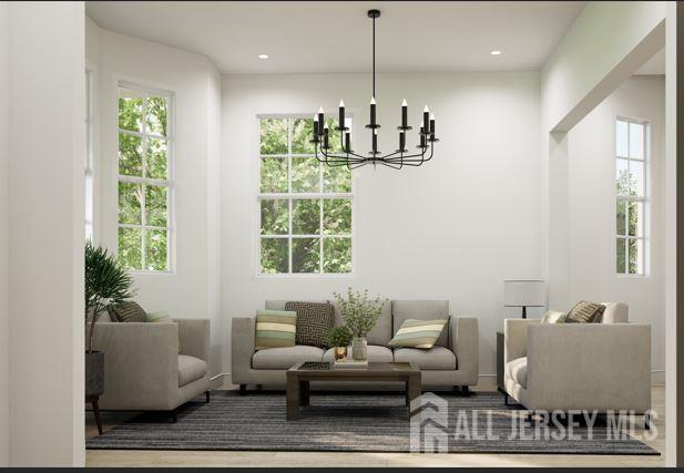 25 Wicker Pl, Morganville, NJ 07751 - living room featuring a chandelier, baseboards, and recessed lighting
