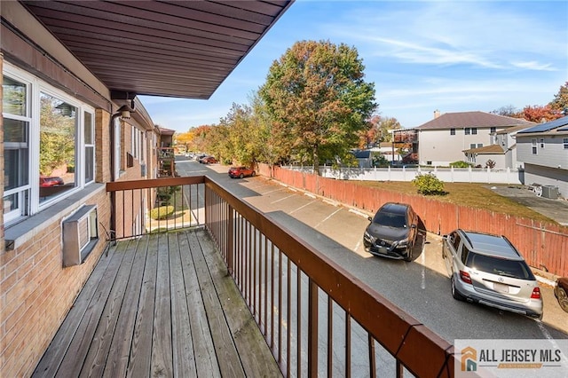 deck with a residential view and fence