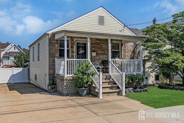 bungalow with a porch and a front yard