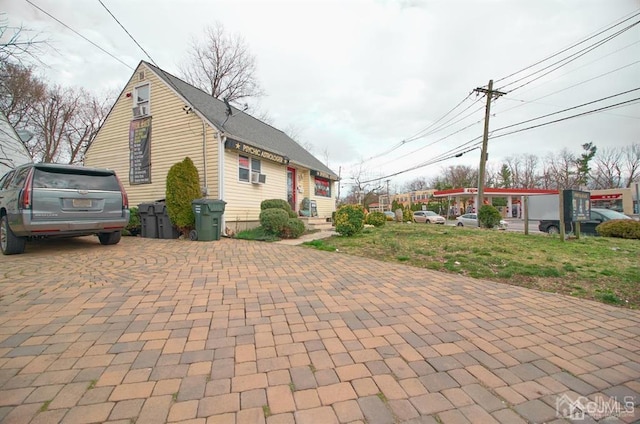 view of side of home with a lawn