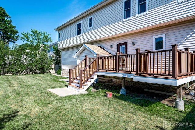 back of house featuring a yard and a wooden deck