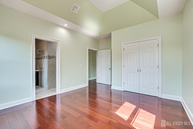 unfurnished bedroom featuring visible vents, baseboards, and wood finished floors