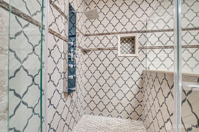 full bath featuring a tile shower