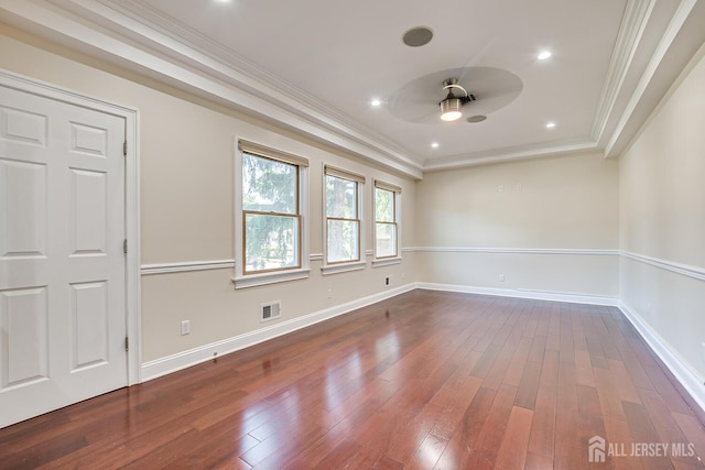 unfurnished room featuring dark wood-type flooring, visible vents, and crown molding