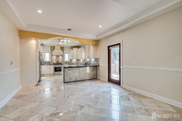 kitchen featuring visible vents, dark countertops, custom range hood, appliances with stainless steel finishes, and backsplash