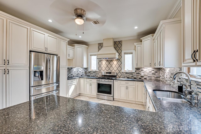 kitchen featuring a sink, ornamental molding, appliances with stainless steel finishes, tasteful backsplash, and custom range hood