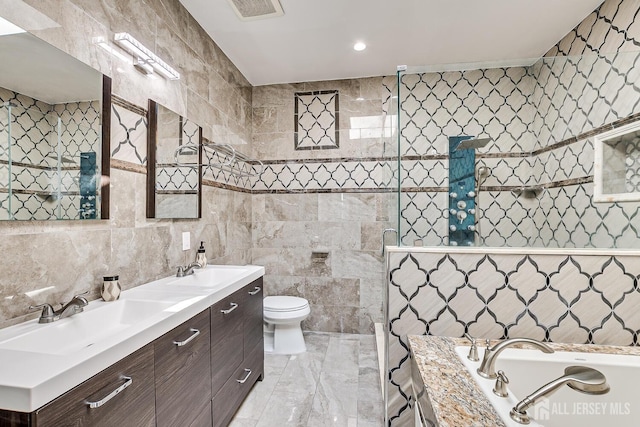 bathroom with tile walls, a sink, and a tile shower