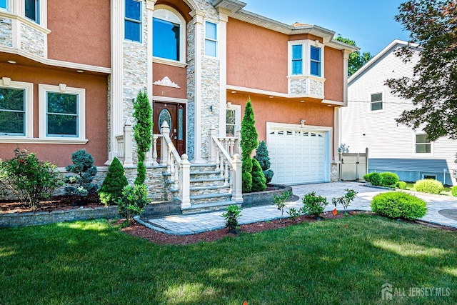 view of front of house featuring a garage, driveway, stone siding, stucco siding, and a front yard