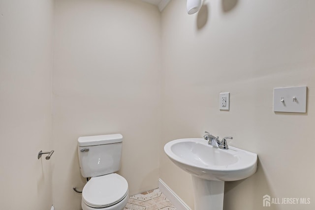 half bath featuring a sink and toilet