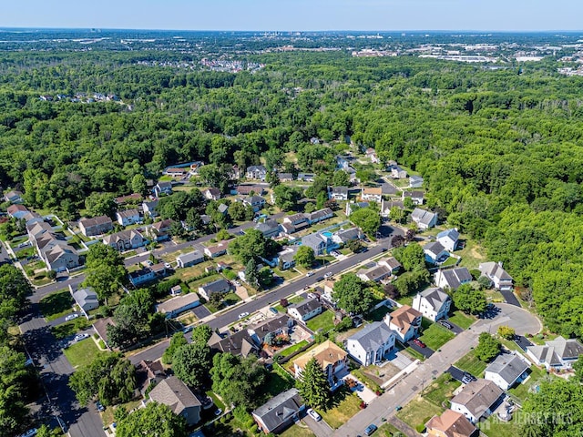 bird's eye view featuring a forest view and a residential view