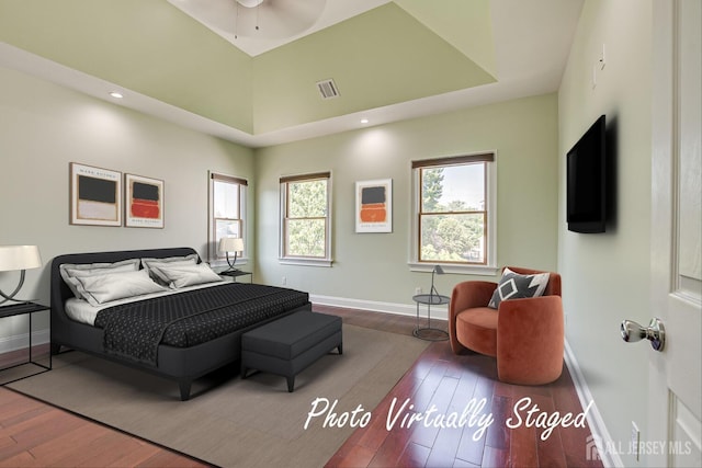 bedroom with hardwood / wood-style flooring, baseboards, and visible vents