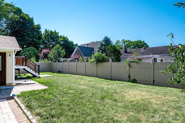 view of yard featuring stairs and fence