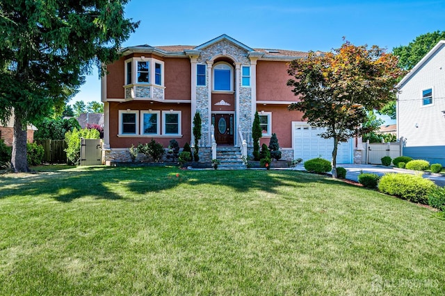 view of front of property with a garage, stone siding, fence, and stucco siding