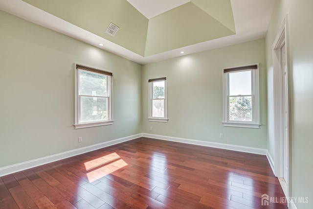 spare room featuring recessed lighting, visible vents, dark wood finished floors, and baseboards