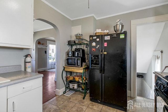 340 Runyon Ave, Middlesex, NJ 08846 - kitchen with black refrigerator with ice dispenser, gas range oven, arched walkways, stainless steel microwave, and plenty of natural light
