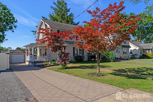 340 Runyon Ave, Middlesex, NJ 08846 - view of property hidden behind natural elements with an outdoor structure, decorative driveway, covered porch, a front yard, and a garage