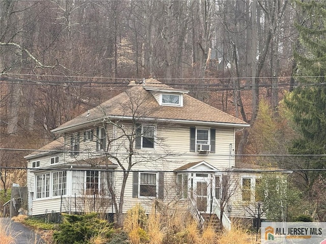 55 Mendham Ave, Morris Twp, NJ 07960 - view of front of house with cooling unit, crawl space, roof with shingles, and a wooded view