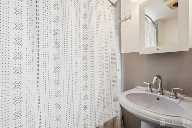 full bathroom featuring a sink