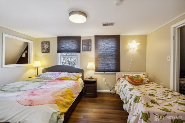 bedroom featuring dark wood finished floors, visible vents, and baseboards