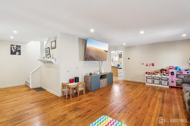 game room featuring recessed lighting, baseboards, and wood-type flooring