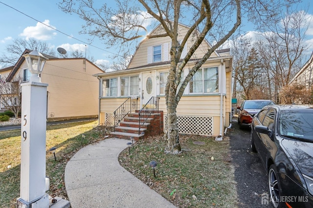 bungalow-style house with entry steps