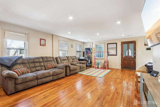 living room with recessed lighting and light wood-type flooring