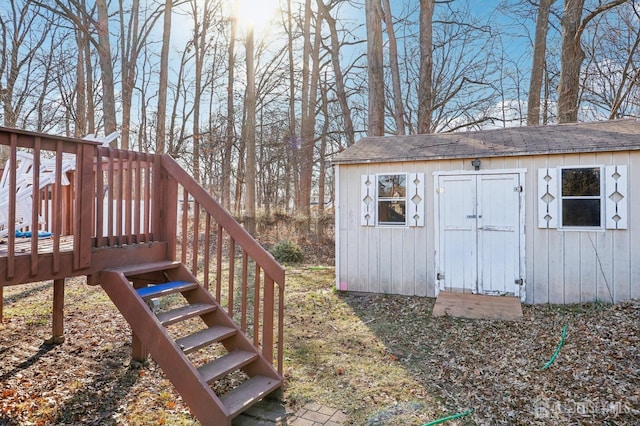 view of outbuilding featuring stairway and an outdoor structure