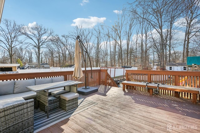 deck featuring an outdoor hangout area and fence