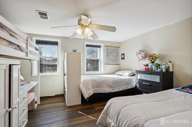 bedroom featuring ceiling fan, dark wood-style floors, visible vents, and baseboards