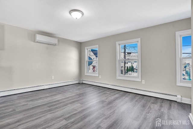 empty room with a baseboard radiator, a wall mounted air conditioner, and wood finished floors