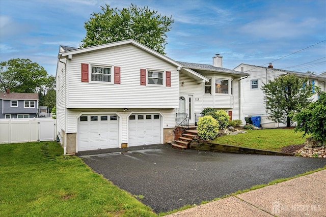 115 Broadway Ave, Colonia, NJ 07067 - bi-level home with driveway, an attached garage, and a chimney