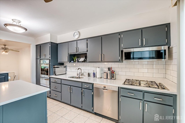 115 Broadway Ave, Colonia, NJ 07067 - kitchen with stainless steel appliances, a sink, backsplash, and ceiling fan