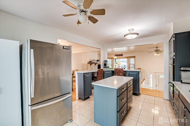 115 Broadway Ave, Colonia, NJ 07067 - kitchen with freestanding refrigerator, a center island, a ceiling fan, and light countertops