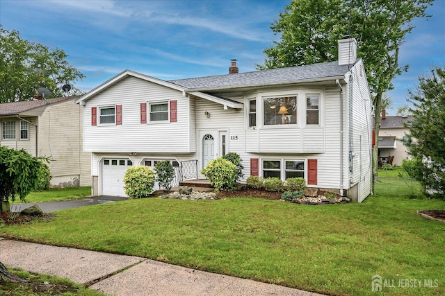 115 Broadway Ave, Colonia, NJ 07067 - split foyer home featuring a chimney, a garage, and driveway