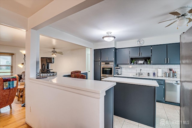 115 Broadway Ave, Colonia, NJ 07067 - kitchen with a ceiling fan, appliances with stainless steel finishes, a sink, and light countertops
