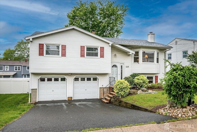 115 Broadway Ave, Colonia, NJ 07067 - raised ranch featuring a garage, a chimney, and asphalt driveway
