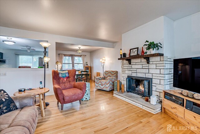 115 Broadway Ave, Colonia, NJ 07067 - living area with wood finished floors, a stone fireplace, and ceiling fan