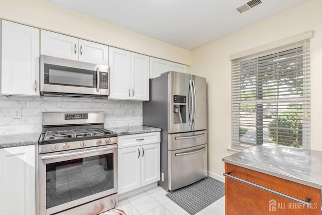 304 Woodbridge Commons Way, Iselin, NJ 08830 - kitchen with stainless steel appliances, white cabinetry, backsplash, and light stone countertops
